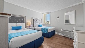 A hotel room with two beds, a large window, a mirror, and a radiator. - Pelican Pointe 429:Walk to Beach~Pool~Free Parking (Clearwater Beach)