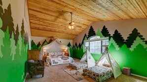 A cozy bedroom with a bed, a tent, and a window. - Huge Cabin Near Woodland Lake, Sleeps 36! (Pinetop-Lakeside)