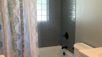 Combined shower/tub, hair dryer, towels, soap