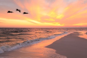 Enjoy a serene beach experience with gentle waves and open space.