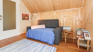 A cozy room with a bed, a small table with books, and a wooden ceiling. - Kellerstoeckl in Strem (Strem)