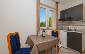 Enjoy meals and socializing in this compact room with a kitchenette and dining area.