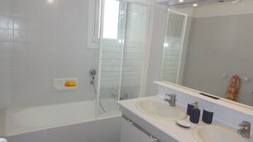 Bathtub, hair dryer, towels, soap