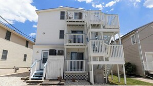 A multi-story building with a central staircase and multiple balconies. - 2 Bd Beach Condo only 2 min walk to OC's Goldcoast (Ocean City)