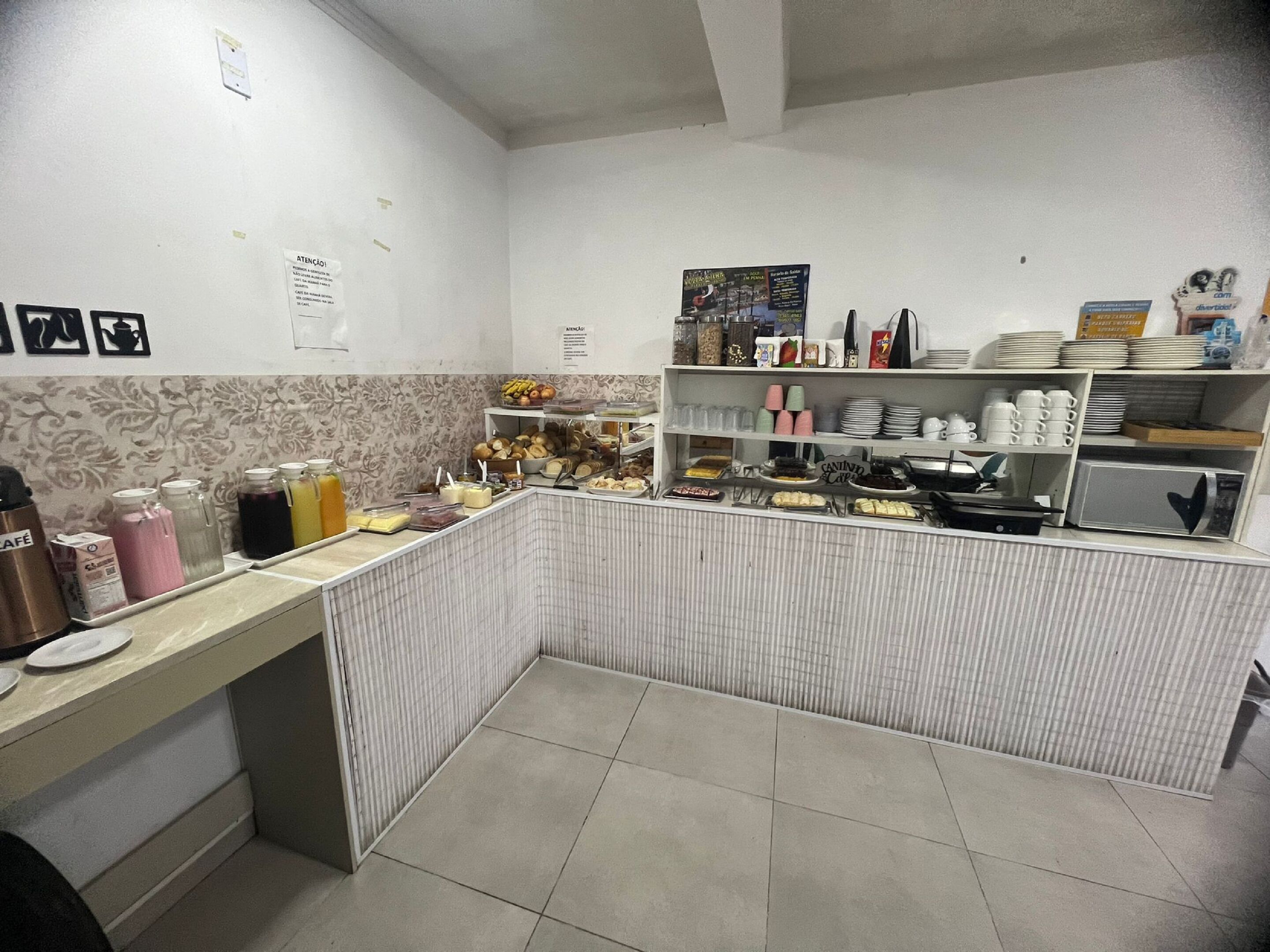 A kitchen area with a counter displaying various food items and utensils.