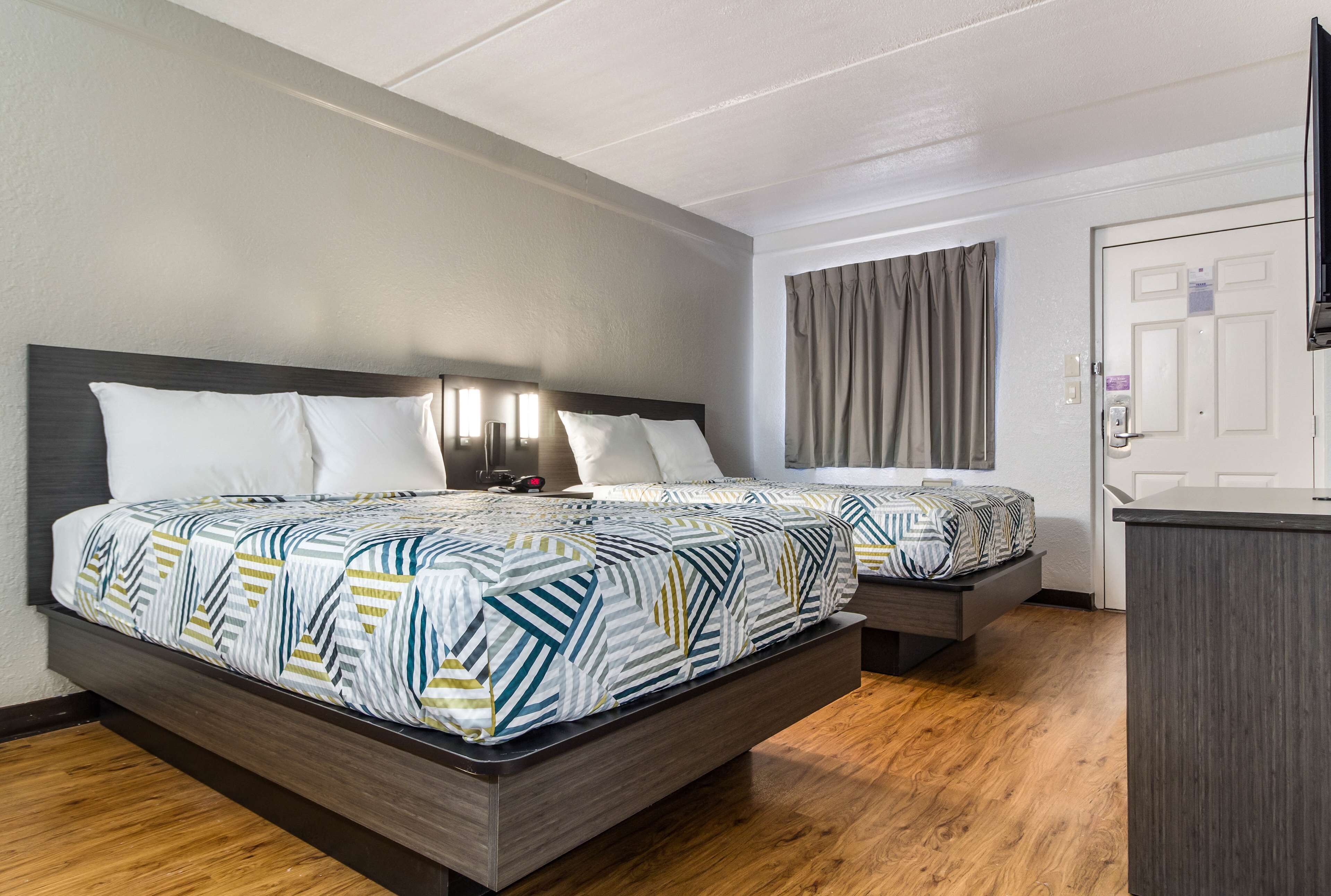 Premium bedding, desk, laptop workspace, blackout drapes