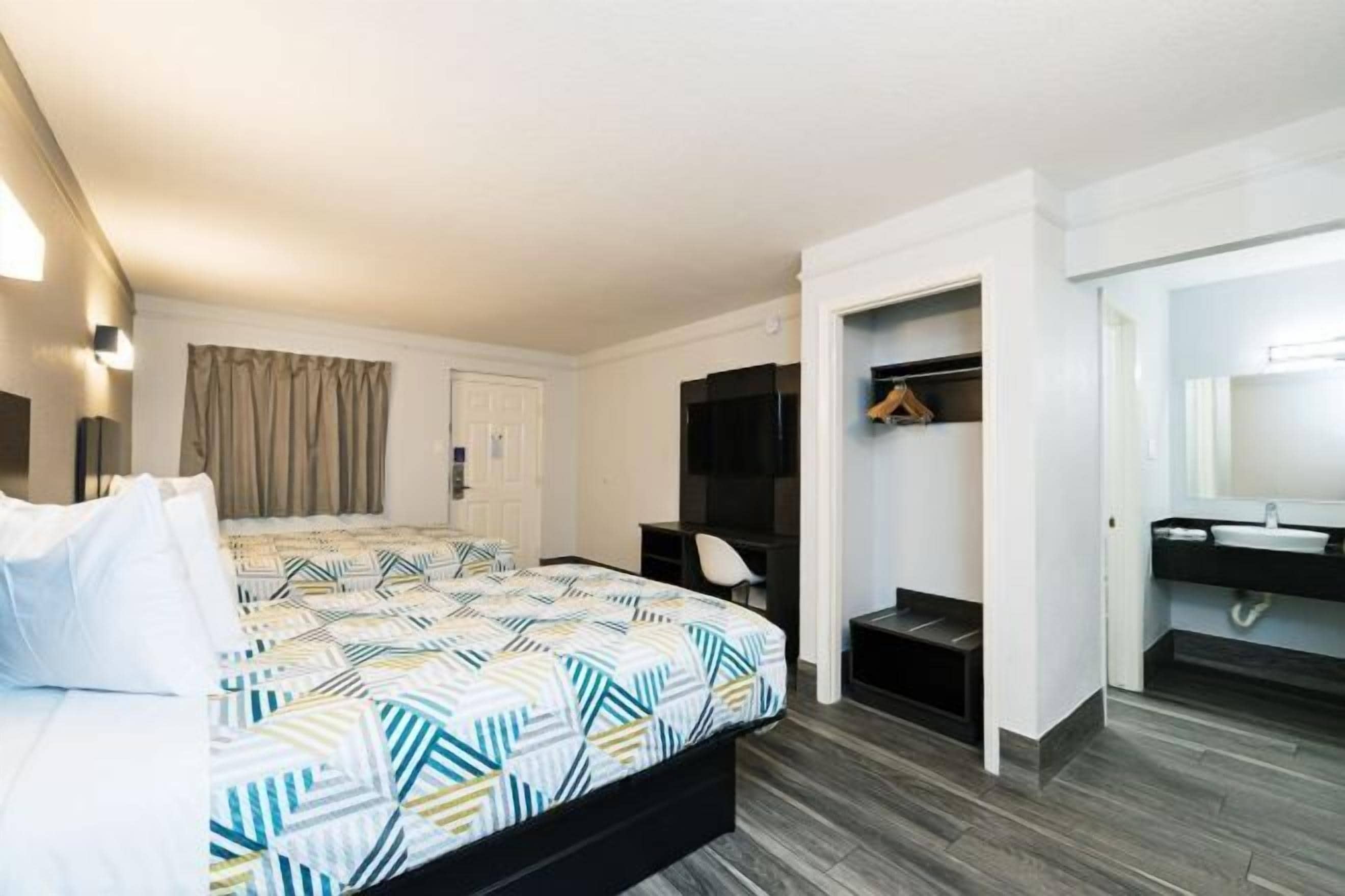 Premium bedding, desk, laptop workspace, blackout drapes