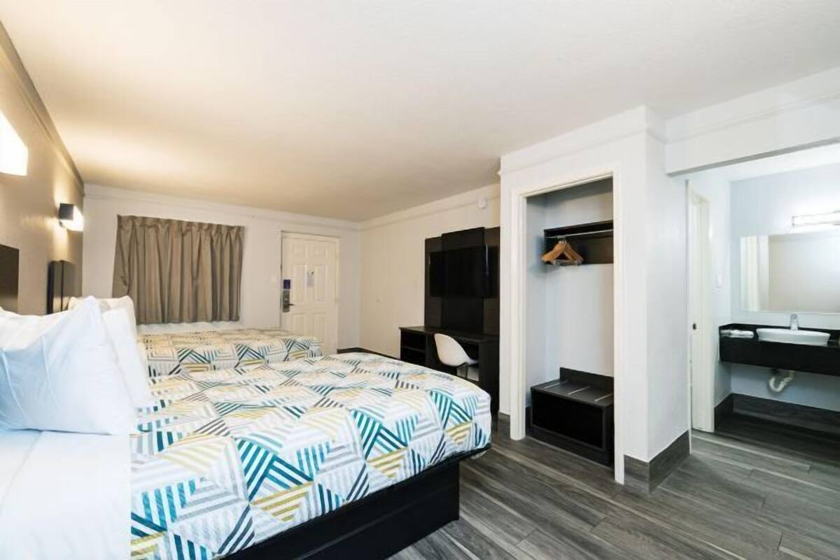 Premium bedding, desk, laptop workspace, blackout drapes