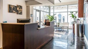 Guests can relax in the reception area, surrounded by artwork and a view of the exterior.