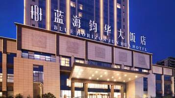 A hotel with a prominent entrance and signage.