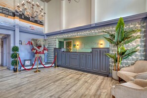 A hotel reception area with a large elephant statue, a reception desk, and a seating area. - SureStay Hotel by Best Western Tuscaloosa Southeast (Tuscaloosa)