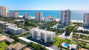 A resort with multiple high-rise buildings, a beach, and a pool area.