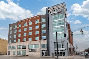 A multi-story hotel with a modern design, featuring a prominent 'Cambria Hotel' sign on the top.