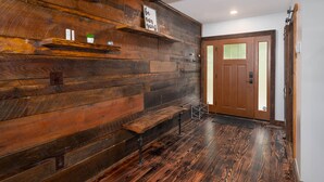 A wooden wall with shelves, a bench, and a door. - The Church (Hendersonville)