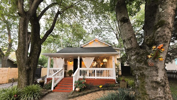 A house with a porch, steps, and a front door.