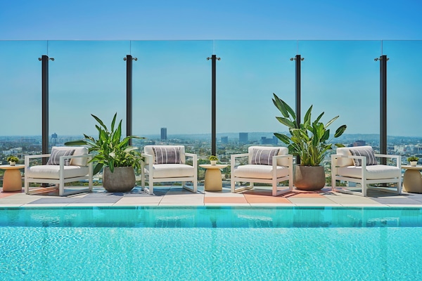 Outdoor pool, open 7:00 AM to 7:00 PM, pool umbrellas, sun loungers