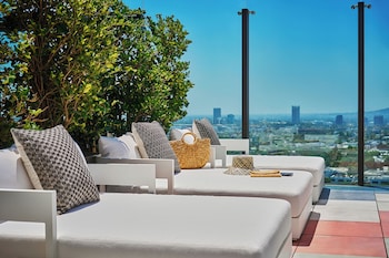Outdoor pool, open 7:00 AM to 7:00 PM, pool umbrellas, sun loungers at The Sun Rose West Hollywood
