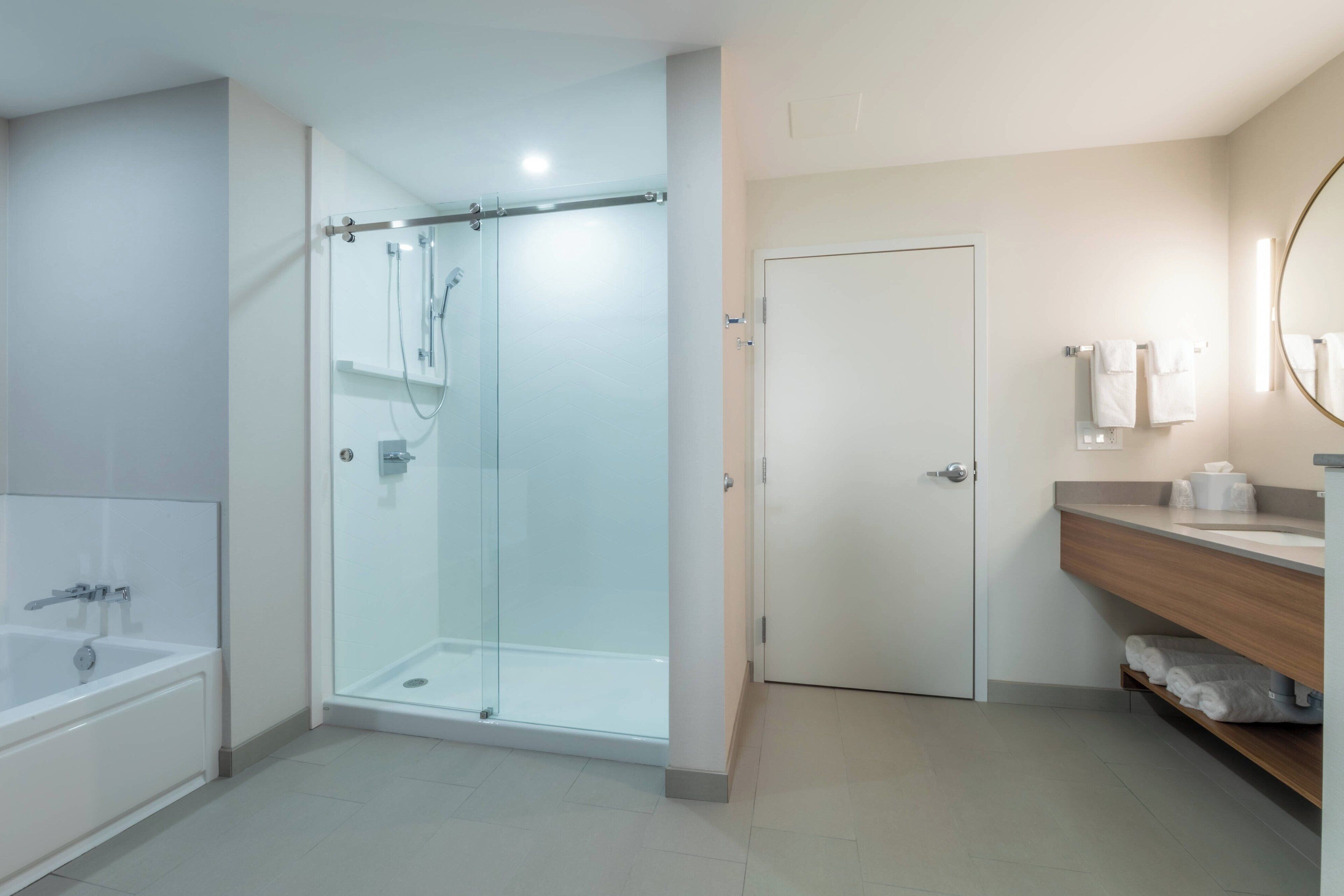 combined shower/bathtub, designer toiletries, hair dryer, towels