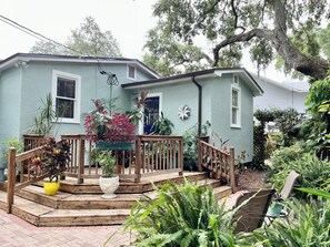 Enjoy a serene retreat with a porch and lush garden surroundings.