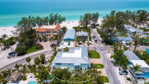 A coastal property with a large house, a smaller building, and a beach view. - Lux Ocean View 4x4 for the Holidays! (Holmes Beach)