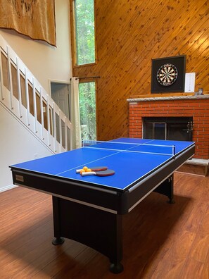 Relax in this cozy space with a foosball table and dartboard, plus a fireplace for warmth.