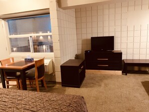 Classic Studio Suite, Non Smoking, Kitchen | Living area | 32-inch flat-screen TV with cable channels, TV, heated floors - Red Carpet Inn & Suites Calgary (Calgary)
