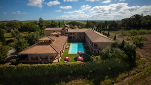 Eine großzügige Villa mit Swimmingpool, mehreren Gästezimmern und einem üppigen Garten.