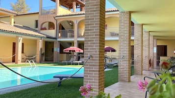Seasonal outdoor pool, open 9:30 AM to 7:30 PM, pool umbrellas