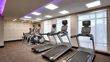 A gym with treadmills, stationary bikes, and ellipticals.