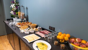 A buffet with various food items including fruits, pastries, and breakfast dishes. -  Boutique Hôtel Nice Côte d'Azur (Nice)