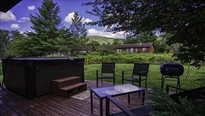 A wooden deck with outdoor furniture, a hot tub, and a barbecue grill. - YR10- AC! Pet Friendly! Hot tub! (Davis)