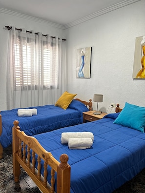 A hotel room with two beds, a nightstand, a lamp, and artwork on the walls. - Holiday Home Casa del Molino with Sea & Mountain Views, Wi-Fi, and Terrace (Icod de los Vinos)