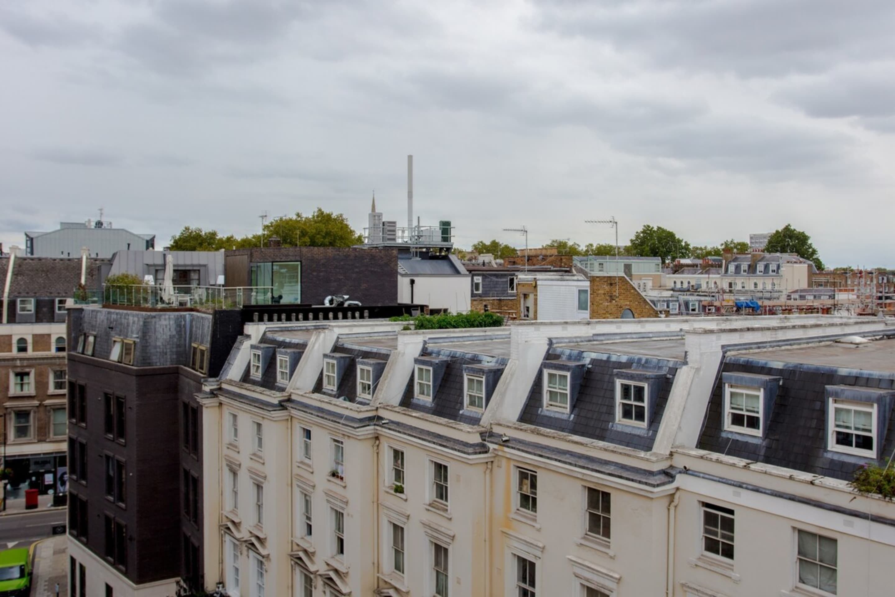 A row of traditional European buildings with steeply pitched roofs and multiple stories.