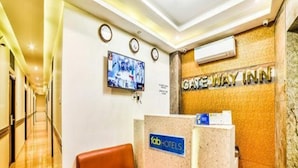 A hotel reception area with a reception desk, a television mounted on the wall, and a sign for the Gateway Inn. - Hotel Gateway Inn (Mumbai)
