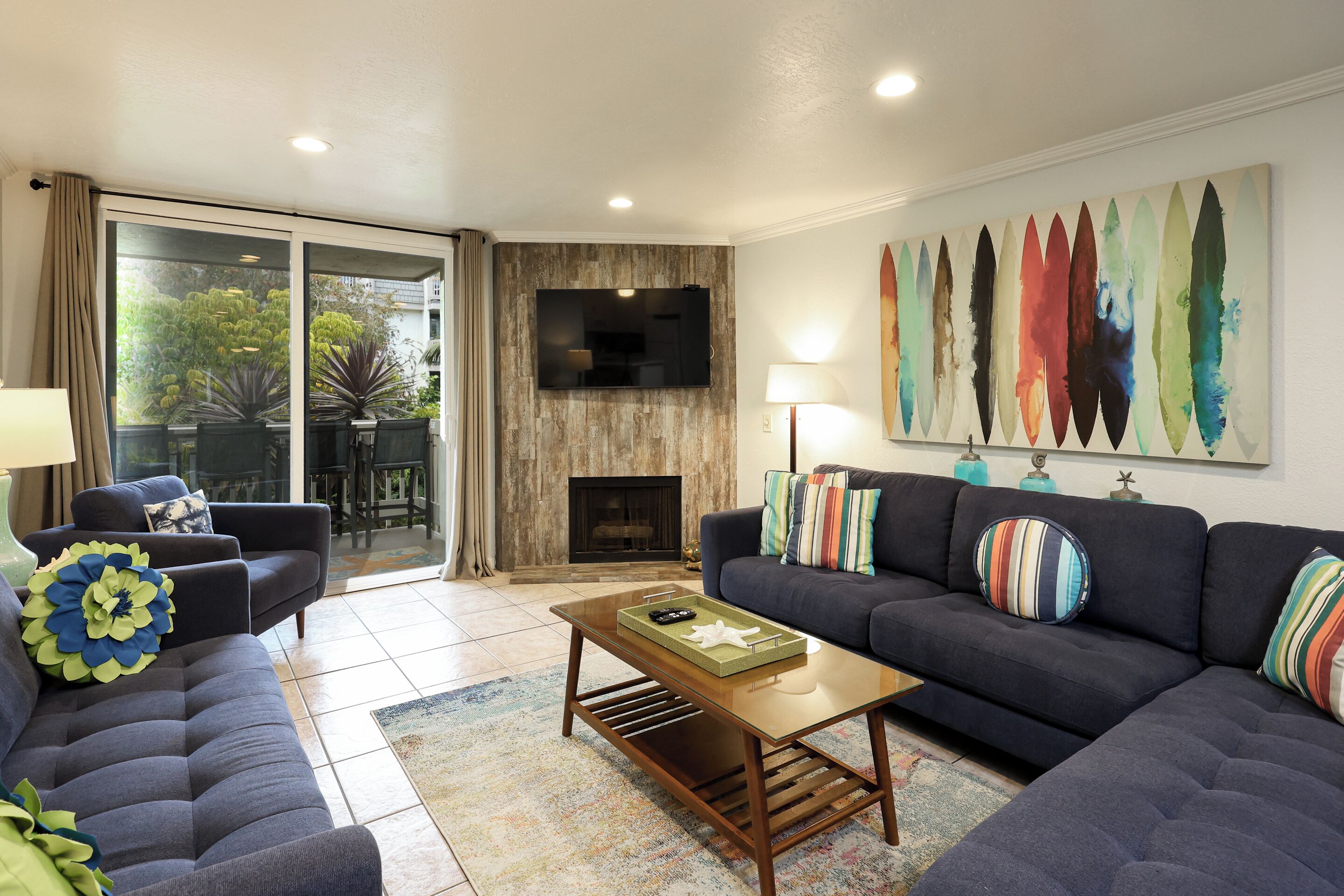A modern living room with a sofa, a coffee table, and a TV mounted on a wall.