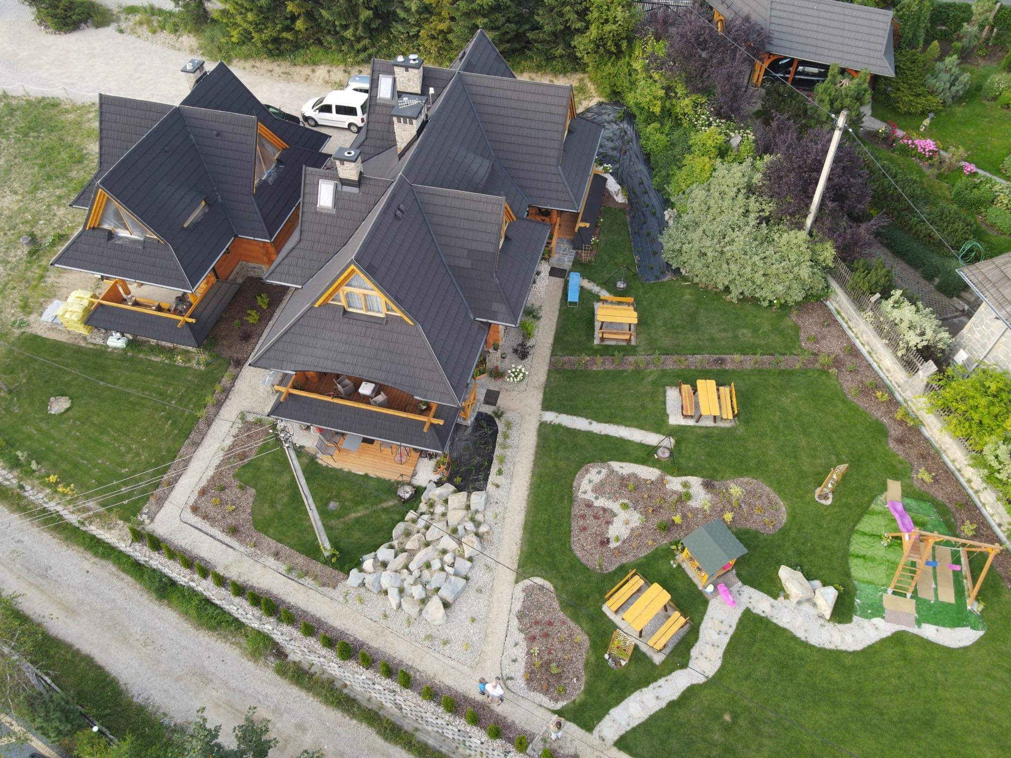 A large, multi-story house with a prominent front porch and a well-maintained lawn.