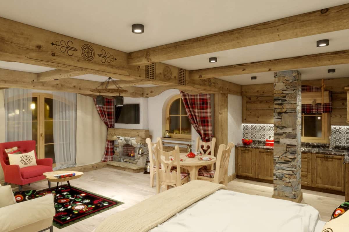 Una habitación acogedora con chimenea, comedor y cocina con armarios de madera.