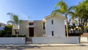 A modern two-story house with a flat roof, a visible satellite dish, and a small front porch. - At Last You can Rent the Perfect Luxury Villa in Larnaca, Larnaca Villa 1392 (Pervolia)