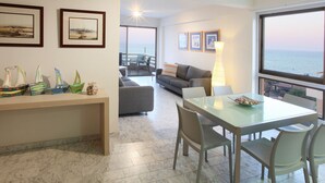 A modern living room with a dining area, a sofa, a coffee table, and a view of the sea. - You Will Love This Luxury Apartment With Stunning Sea Views, Larnaca Apartment 1384 (Larnaca)