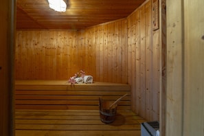 A wooden sauna room with benches, a wooden bucket, and a thermometer on the wall. - Your Beautiful Holiday Villa Minutes From the Beach, Protaras Villa 1492 (Paralimni)