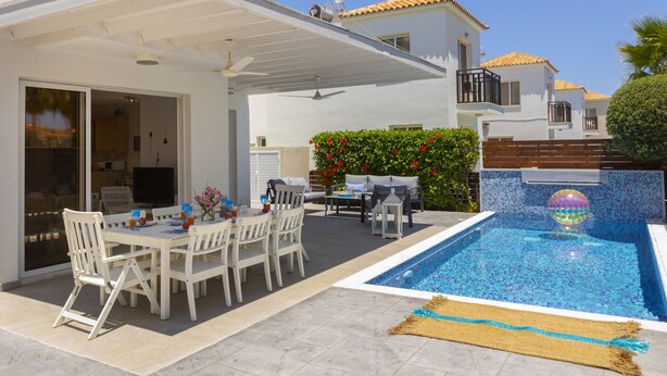 A residential property with a covered patio, a swimming pool, and a garden. - Ultimate Beachside Luxury: Protaras Villa 1461 (Paralimni)