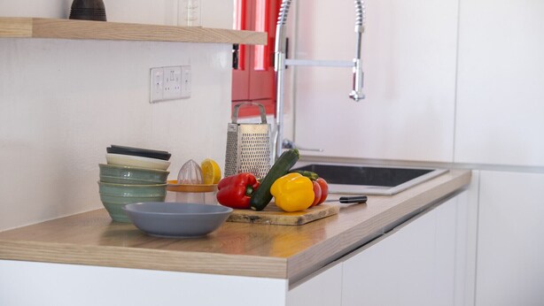 A kitchen with a wooden countertop, a sink, and various kitchen utensils. - Discover Perfect Holiday Escape in Protaras, 1411 (Paralimni)