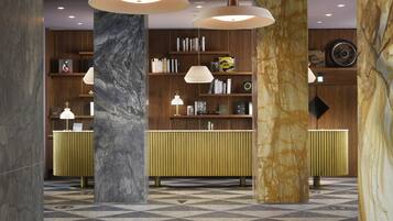 A lobby with marble columns, a checkered floor, and a wooden reception desk with bookshelves.
