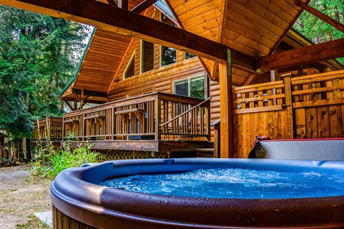Elegant, secluded home with a wood deck, gas grill, & private hot tub