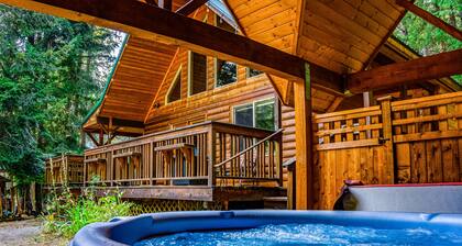 Elegant, secluded home with a wood deck, gas grill, & private hot tub
