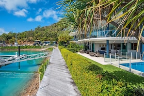 Relax by the pool surrounded by lush greenery and take in the breathtaking views of the surrounding landscape.