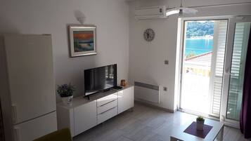 Standard Apartment, Balcony, Sea View | Living area | Flat-screen TV