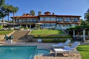 A large resort with a swimming pool, outdoor seating, and a well-maintained lawn. - Apogee Boutique Hotel & Spa (Pretoria)