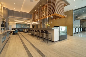 A modern hotel lobby with a central bar area, seating, and a decorative wall. - Bayfront Hotel Cebu - Capitol Site (Cebu City)
