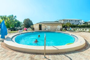 A circular pool with a metal safety rail, surrounded by a brick patio. - 🌊Walk 2 Beach~2 Pools~Pool Views~2BR The Islander 211 (Destin)